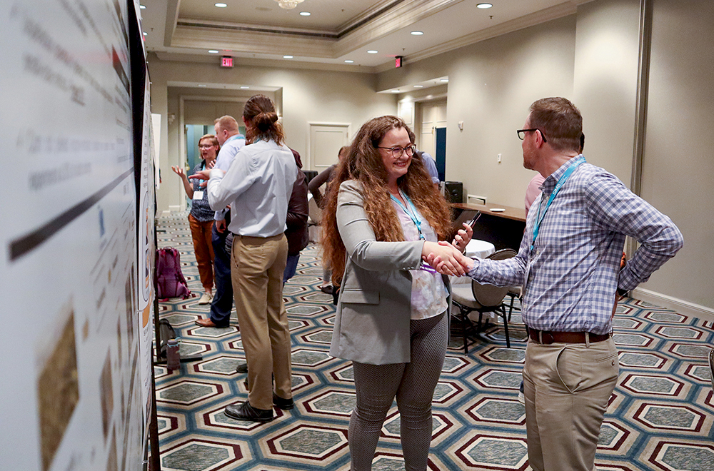Photo of two attendees in the poster hall at the 44th SBFC conference